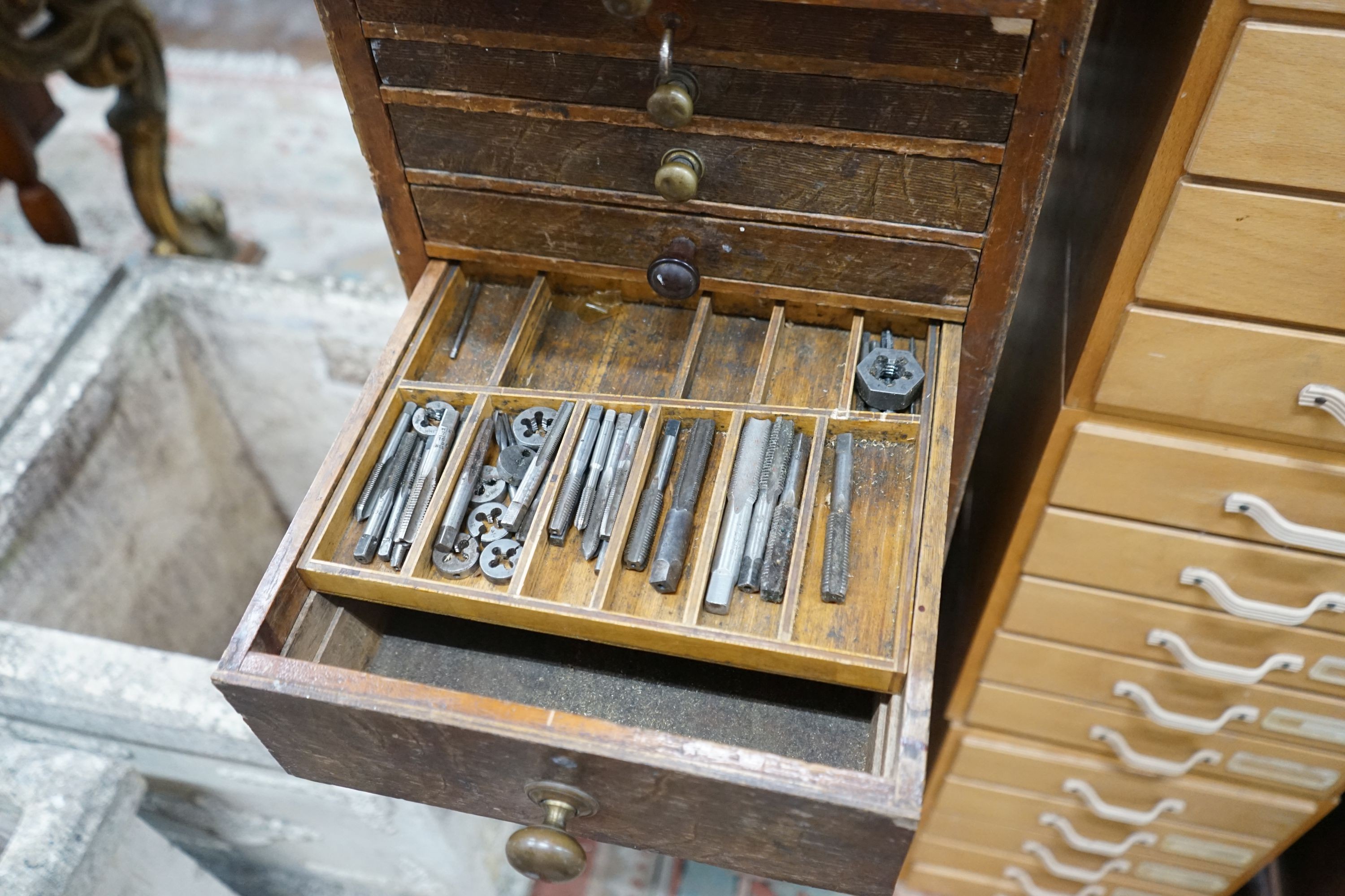 A vintage 11 drawer narrow chest containing assorted tools, height 108cm, together with an oak two drawer filing chest